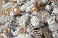 Close up photo of toy balls in silver and gold on trendy luxury snowy Christmas tree