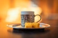 Close-up photo of a traditional Turkish dibek coffee served with porcelain chinaware cup and Turkish delight on a table