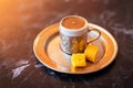 Close-up photo of a traditional Turkish dibek coffee served with porcelain chinaware cup and Turkish delight on a table