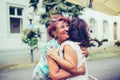 Close-up photo of two emotional happy senior female friends hugging each other Royalty Free Stock Photo