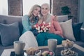 Close up photo two people she her ladies grandmother grandchildren visit birthday party fresh flowers overjoyed enjoy