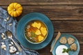 Close-up photo of two plates with fresh homemade pumpkin cream soup with seeds and heart shape toasts Royalty Free Stock Photo