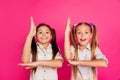 Close up photo two small little age she her girls raise arms in school begging teacher answer theme wearing casual jeans Royalty Free Stock Photo