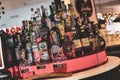 A close-up photo of various types of alcoholic bottles lined up on a bar shelf. Perfect for showcasing bar and nightlife scenes