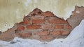 Close up photo of the wall damaged and with holes visible until the bricks are visible. No people. Selective focus Royalty Free Stock Photo