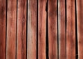 Old, rustic wooden wall painted with red ochre