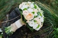 Close-up photo of wedding bouquet made of roses on the stump. Royalty Free Stock Photo