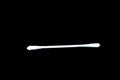 Close-up photo of a white cotton bud on a black background Royalty Free Stock Photo