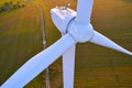 Close-up photo of a wind turbine from the air early in the morning in backlight