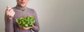 Close up photo of woman eating mediterannean salad with happy face.