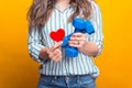 Close up photo of woman hands holding dumbbells and red paper heart. love sport