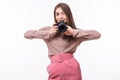 Portrait of woman in hat taking a photo with digital camera on white background Royalty Free Stock Photo