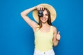 Close up photo of woman in hat on blue taking a photo with digital camera Royalty Free Stock Photo