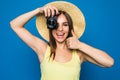 Close up photo of woman in hat on blue taking a photo with digital camera Royalty Free Stock Photo