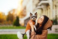 Close-up photo, a woman holding a biewer terrier dog and looking away. Walk with pet concept. Close-up photo, a woman holding a