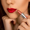 Close up photo of woman lips with lipstick in hand Royalty Free Stock Photo