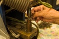 Close-up photo of woman`s hand electronically welding a part