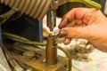 Close-up photo of woman`s hand electronically welding a part