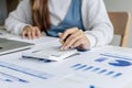 Close-up photo A woman`s hand is pressing a calculator. Royalty Free Stock Photo