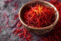 A close-up photo of a wooden bowl filled with red saffroni, showcasing the vibrant color and texture of the spice, Cupful of