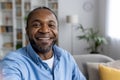 Close-up photo of a young African American man taking a selfie, holding a camera and talking while smiling on a video Royalty Free Stock Photo