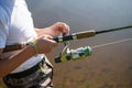 Close-up photo of a young boy fishing outdoors on a summer day.