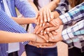 Close-up photo of young friends putting their hands on top of each other. They achievement harmony in team Royalty Free Stock Photo