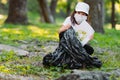 Close up photo of a young girl in a white cap wearing medical face mask holding a paper with the recycled sign drown on Royalty Free Stock Photo