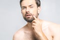 Close up photo of young man looking for acnes on his face Royalty Free Stock Photo