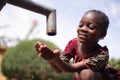 Close up Photograph of African Black Girl Drinking Safe Water from Tap Royalty Free Stock Photo