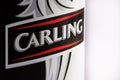 A close up photograph of a can of Carling lager shot against a white backdrop