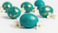 Teal easter eggs decorated with gold leaf and white blossoms on a clean white background Royalty Free Stock Photo