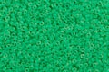 Green glass seed beads background. Royalty Free Stock Photo