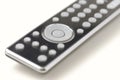 Close up of black remote control with grey navigation buttons on a clean neutral background Royalty Free Stock Photo