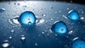 A close-up photograph of several blue water droplets on a surface, capturing the reflection of light and the intricate