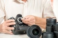 Close up of photographer hand cleaning sensor of his camera