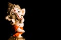 Close up photography of beautiful ganesha statue standing on black background. religious concept