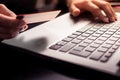 Close up photography of female hands holding a plastic credit card and using laptop. Online shopping concept Royalty Free Stock Photo