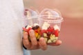 Close up photography of the man`s hands holding two containers greek salad. Takeout healthy food concept Royalty Free Stock Photo