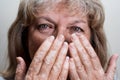 Close up photography of middle age woman looking to the camera with her beautiful green eyes and covering half of her face Royalty Free Stock Photo