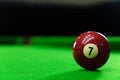 Close-up photos of billiard ball, number 7 and green floor Royalty Free Stock Photo