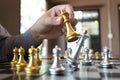 Close-up photos of checkmate hands on a chessboard during a chess game The concept of business victory strategy wins the intellige