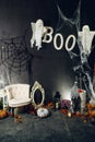 Close up photozone with pumpkins, candles, scary ghost and cobweb for Halloween party