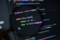 close-up of php source code showing json success response with status and data values under magnifying glass on dark screen Royalty Free Stock Photo