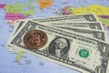 Close up physical bitcoin coin with US dollars and world map. Royalty Free Stock Photo