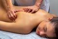 Physiotherapist manipulating shoulder blade on young woman