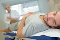 Close-up physiotherapist stretching young patients leg