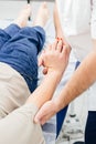 Close-up of a physiotherapist treating a patient. Osteopath holds a woman& x27;s hand