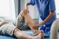 Close up of Physiotherapist working with patient on the bed