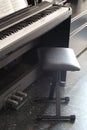 Close up on a piano keyboard with a stool